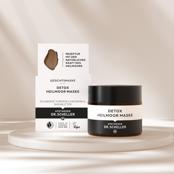 Stimmungsbild der Detox Heilmoor Maske auf dem die Faltschachtel und der Tiegel zu sehen ist